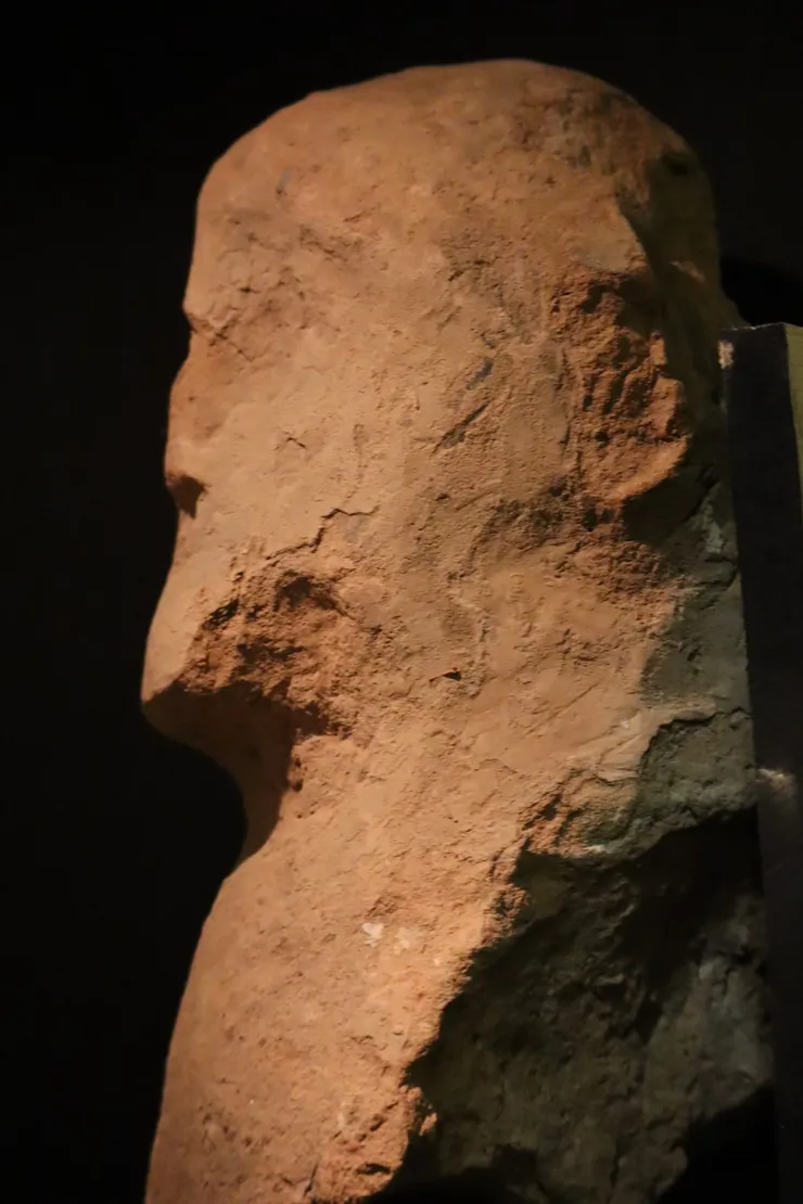 Close-up of an ancient weathered stone sculpture face.