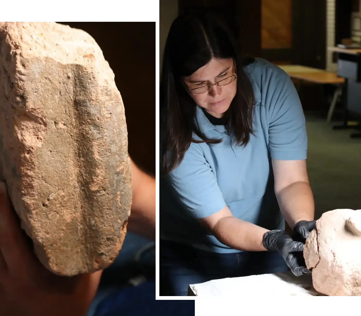 Researcher handling archaeological stone object
